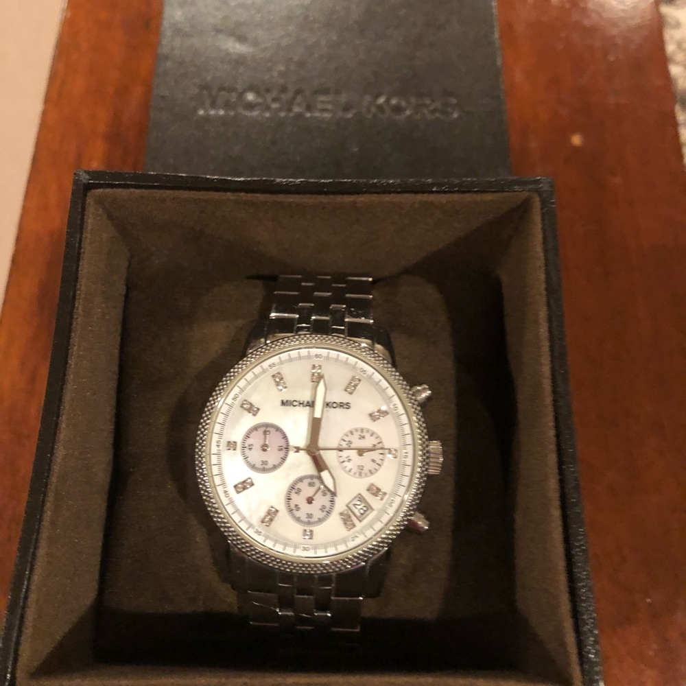 Silver MK watch with Opaque white face.